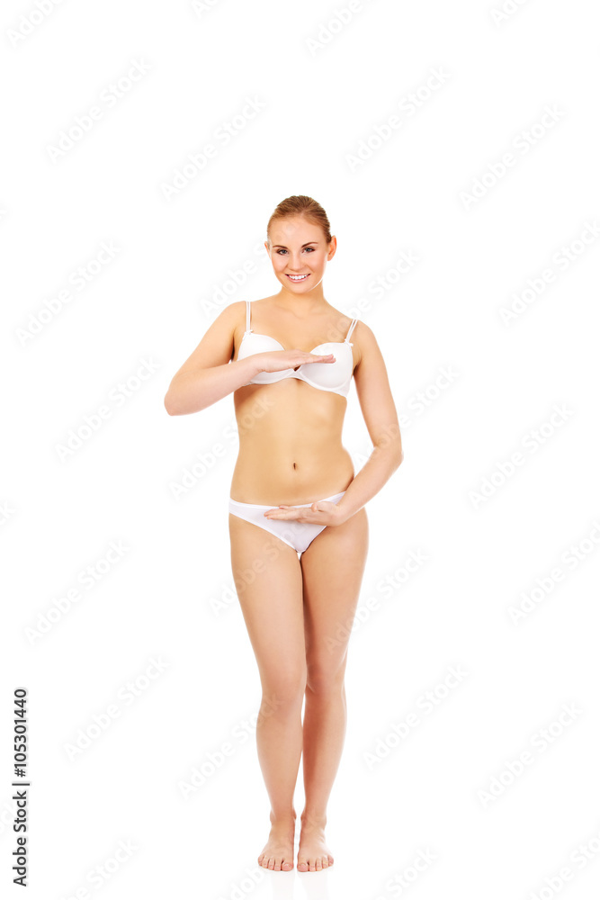 Young woman in white lingerie with hand on belly Young woman in white lingerie with hand on belly
