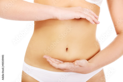 Slim woman belly with hand on it