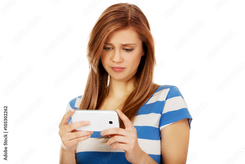 Teenage woman using her smartphone Teenage woman using her smartphone