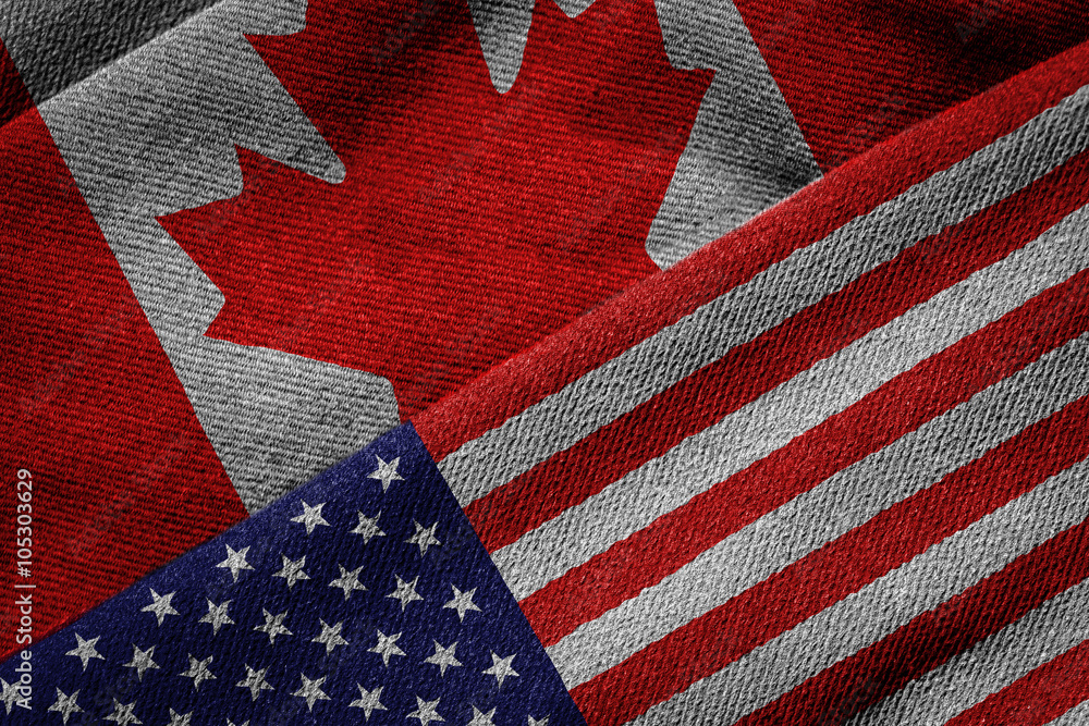 Naklejka premium Flags of USA and Canada on Grunge Texture