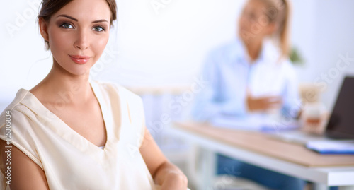 Portrait of a businesswoman sitting at  desk with  laptop