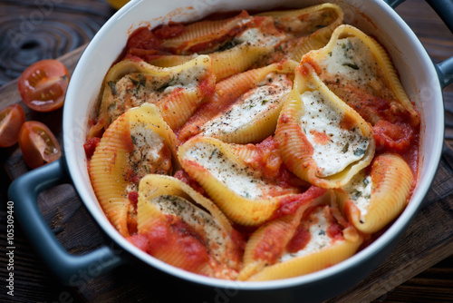 Close-up of conchiglioni baked with cottage cheese