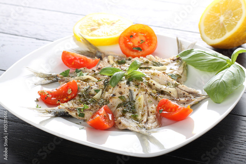 Salad marinated sardines with basil and tomato