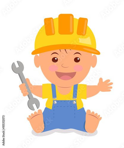 Toddler in the construction hardhat with a wrench in his hand. Isolated child in a helmet, yellow T-shirt and blue overalls with suspenders.