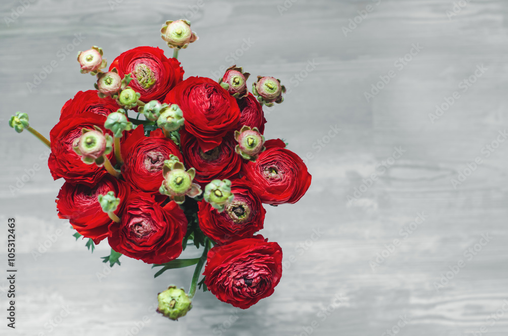 Bouquet of colorful buttercup red flowers ranunculus on wooden Rustic Background