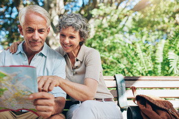 Happy senior tourist  reading map