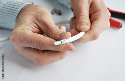 Close up on TV Coaxial Cable Wire Repair in Repairman Hands