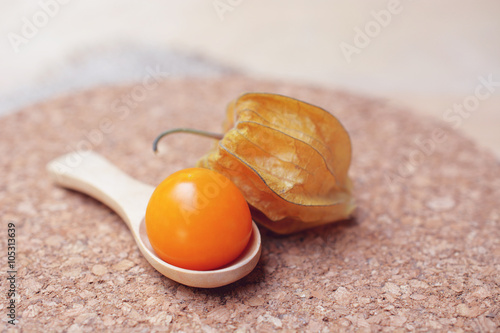 Cape gooseberry (Physalis) on wooden spoon