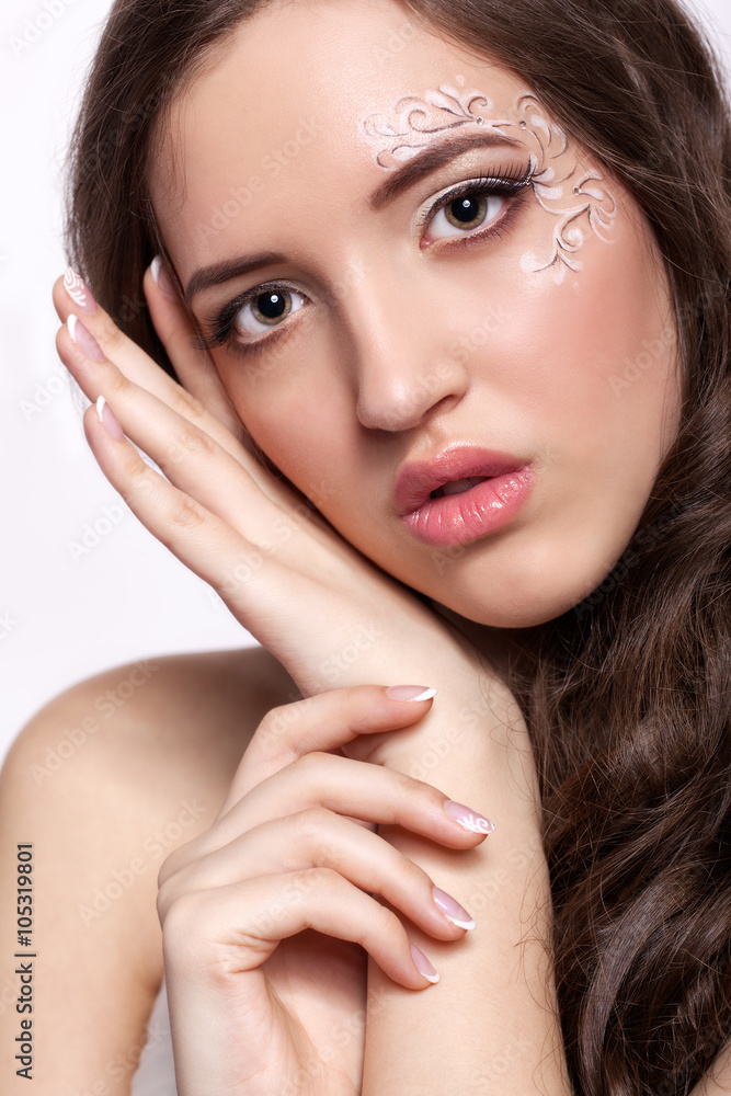 Close-up portrait of young woman with face art make up and mani Close-up portrait of young woman with face art make up and mani
