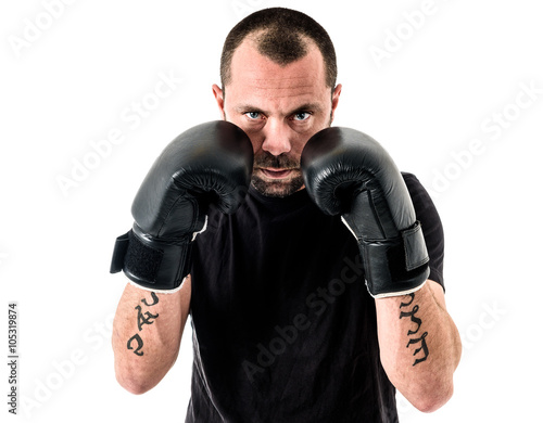 Portrait of male athlete boxer man looking aggressive with boxin photo