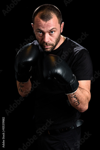 Portrait of male athlete boxer man looking aggressive with boxin © _jure