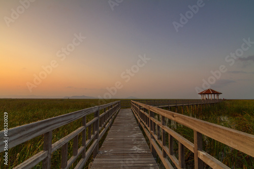 wood walkway of the lake park in sunset time © rukawajung