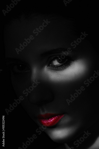 Artistic beauty portrait of young woman with creative lighting