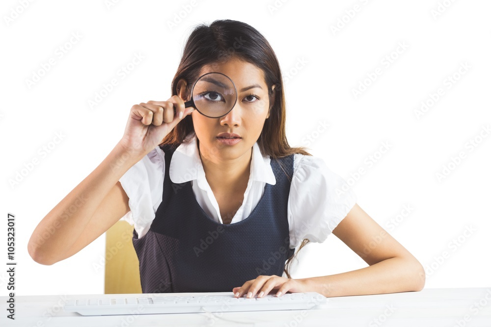 Businesswoman looking through magnifying glass Businesswoman looking through magnifying glass