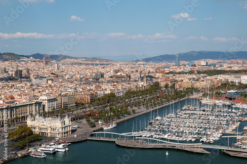  Panoramic view of Port Vell in Barcelona. Sagrada Familia and Torre Agbar are visible in the distance.