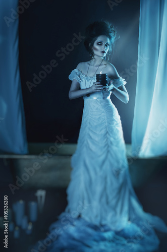 beautiful girl ghost, witch bride in a white dress holding a black burning candle in hands