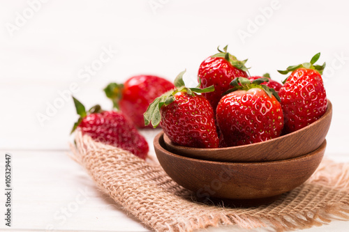 Ripe red strawberries on wooden table, healthy food
