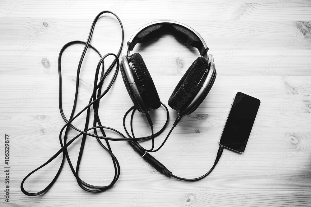 headphones with cellphone on the desk headphones with cellphone on the desk