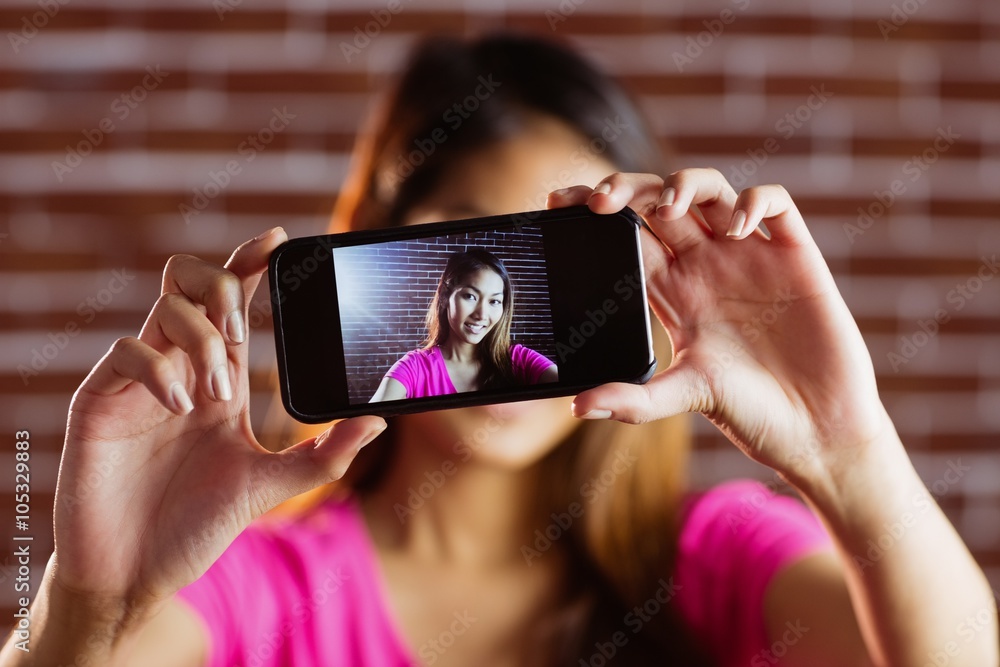 © WavebreakmediaMicro - Smiling asian woman taking picture with camera © WavebreakmediaMicro - Smiling asian woman taking picture with camera