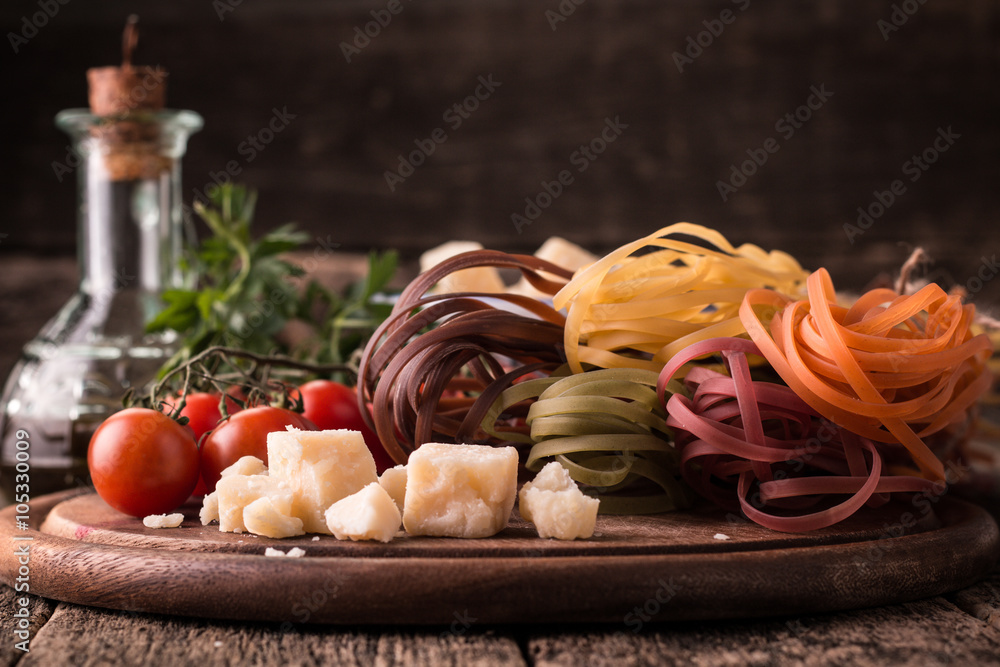  Vegetable color Pasta, oil,tomatoes,cheese on wooden table. italian food