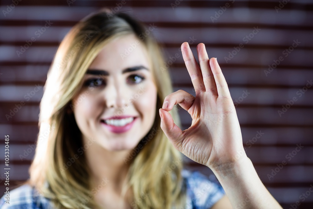 Pretty blonde woman making signs with her fingers Pretty blonde woman making signs with her fingers