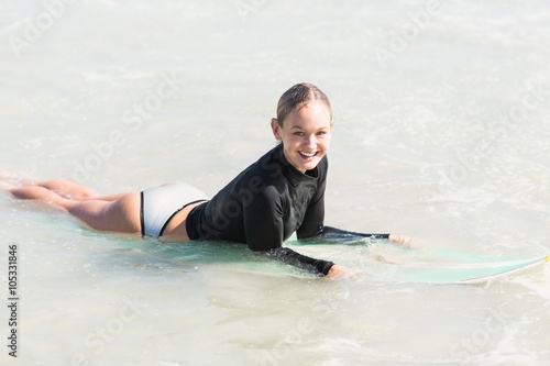 Happy woman lying on surfboard © WavebreakMediaMicro