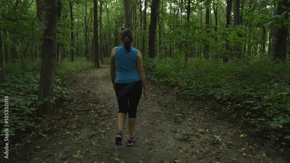 A woman walking in the woods A woman walking in the woods