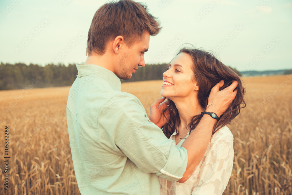 Young couple in love outdoor.Stunning sensual outdoor portrait of young stylish fashion couple posing in summer in field Young couple in love outdoor.Stunning sensual outdoor portrait of young stylish fashion couple posing in summer in field
