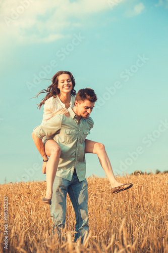 Young couple in love outdoor.Stunning sensual outdoor portrait of young stylish fashion couple posing in summer in field 