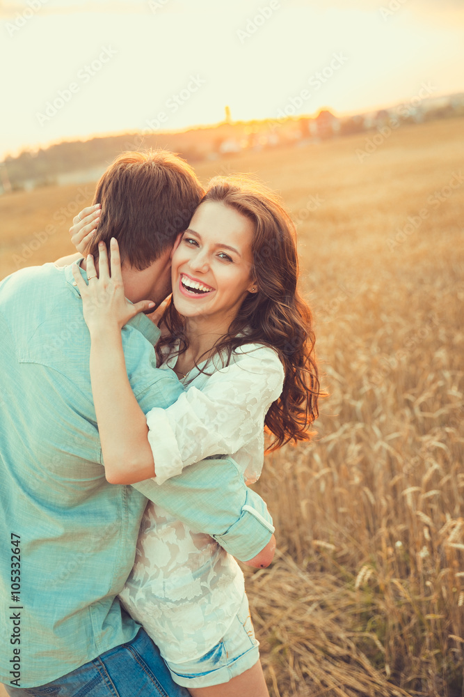Young couple in love outdoor.Stunning sensual outdoor portrait of young stylish fashion couple posing in summer in field Young couple in love outdoor.Stunning sensual outdoor portrait of young stylish fashion couple posing in summer in field