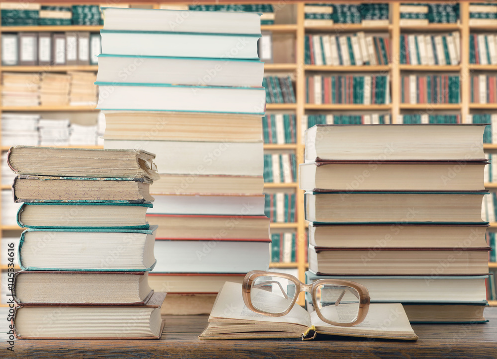 Fototapeta premium Books and eyeglasses In library