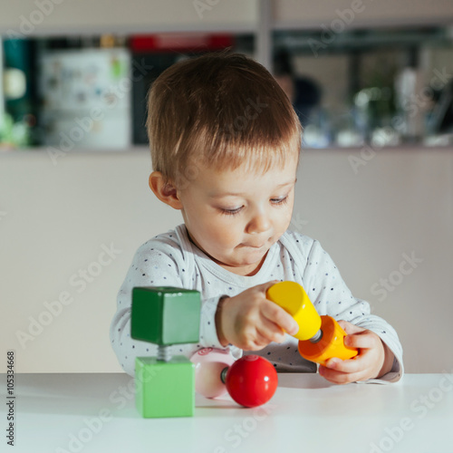 Little Boy Is Playing With Toys