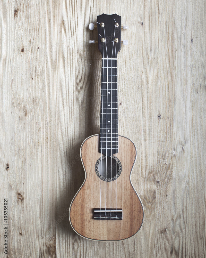 Fototapeta premium ukulele on wooden background. close up