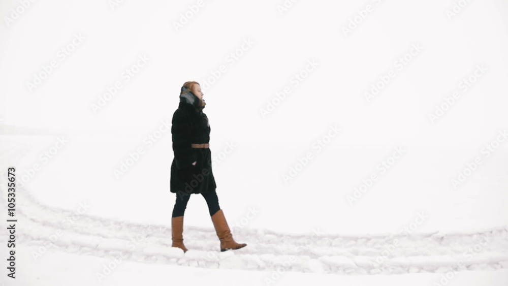 Girl winter walks on foot. Slow motion Girl winter walks on foot. Slow motion