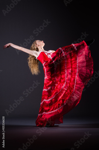 Young woman dancing in red dress