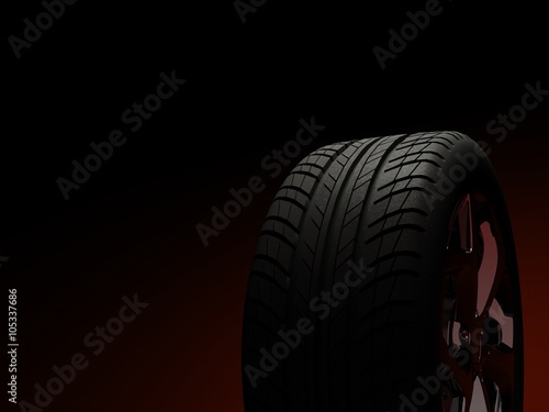 Car tire on dark background.