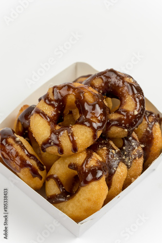 Packaging of donuts with chocolate sauce isolated on white backg