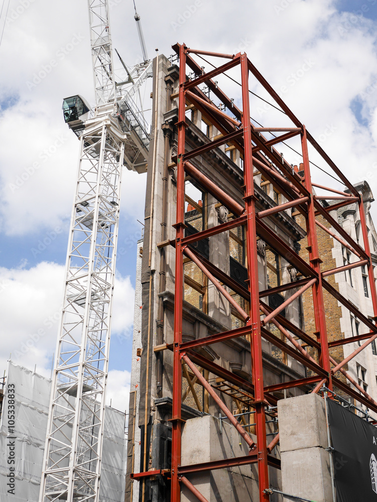 Building Preservation. Construction work on original London buildings with facades being preserved for integration into the new property.