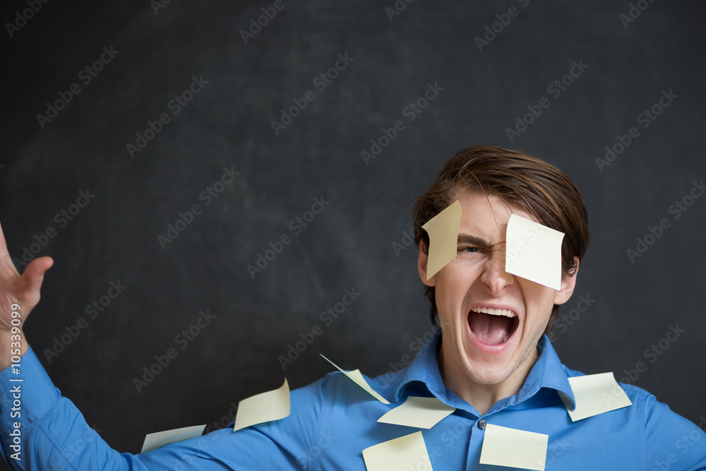Office worker with post-its all over his face