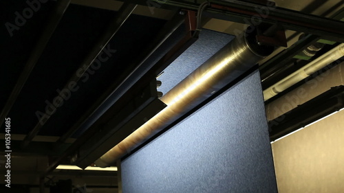 In a carpet factory new rolls of carpet a rolling by on a production line