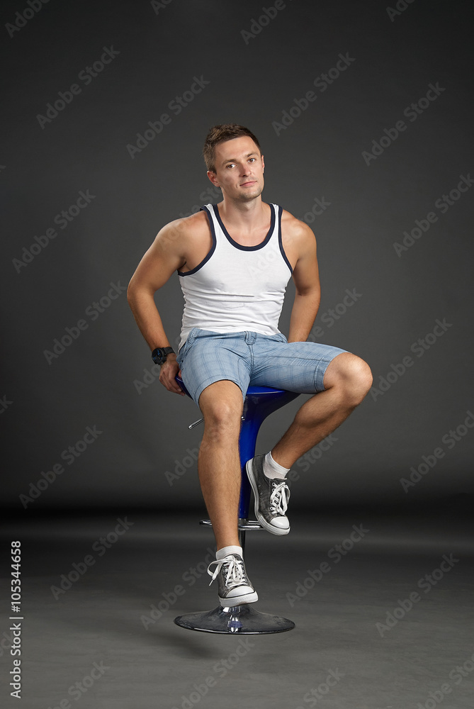 Obraz premium Portrait of a relaxed man sitting on a bar stool