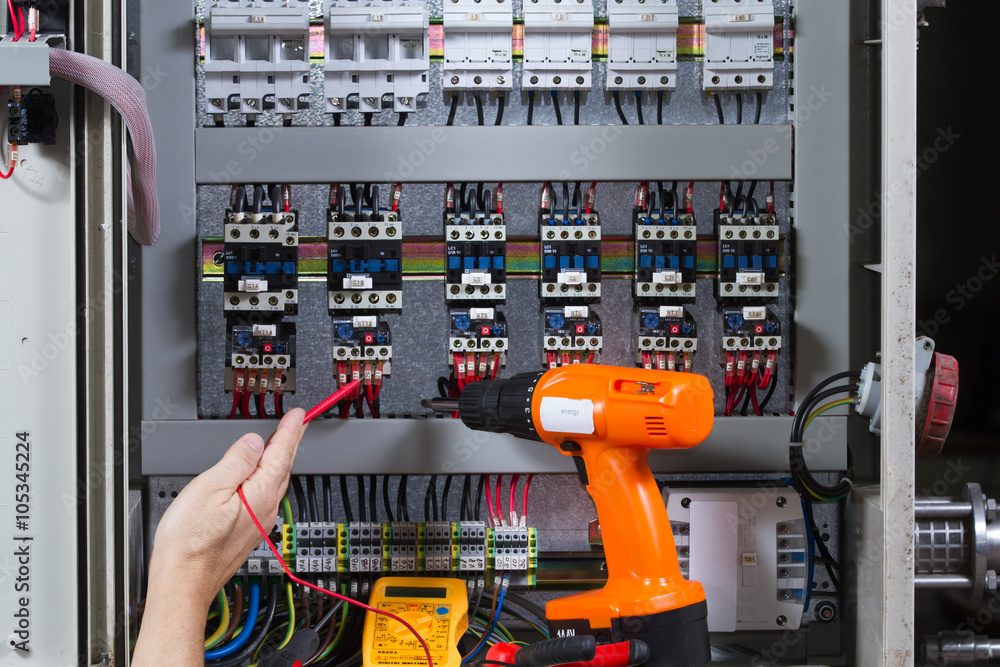electrician at work with an electric panel electrician at work with an electric panel