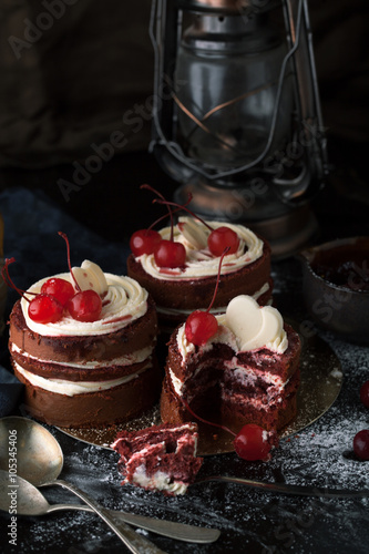 Delicious cake with cherries, icing sugar on a dark