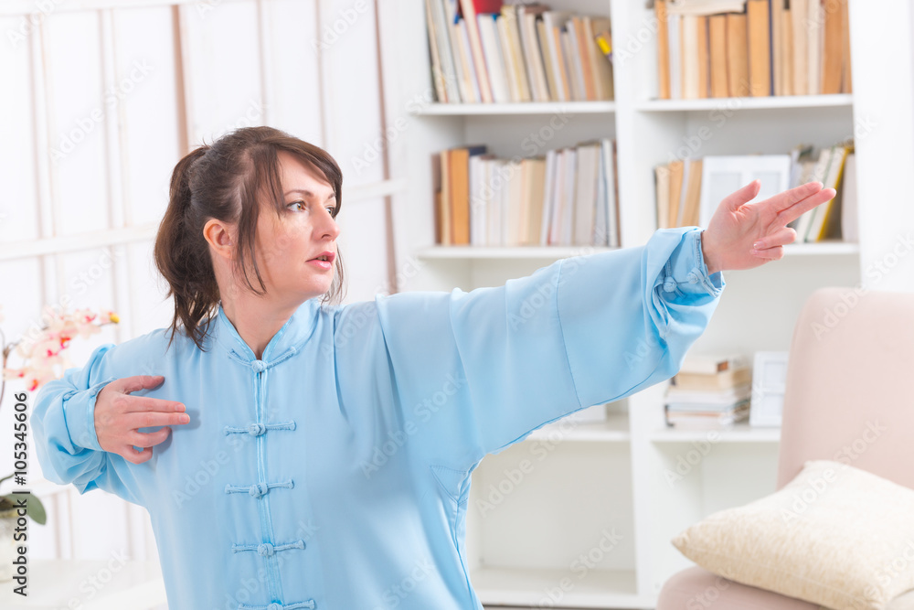 Fototapeta premium Woman doing qi gong tai chi exercise