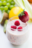 close up of glass with milk shake and fruits