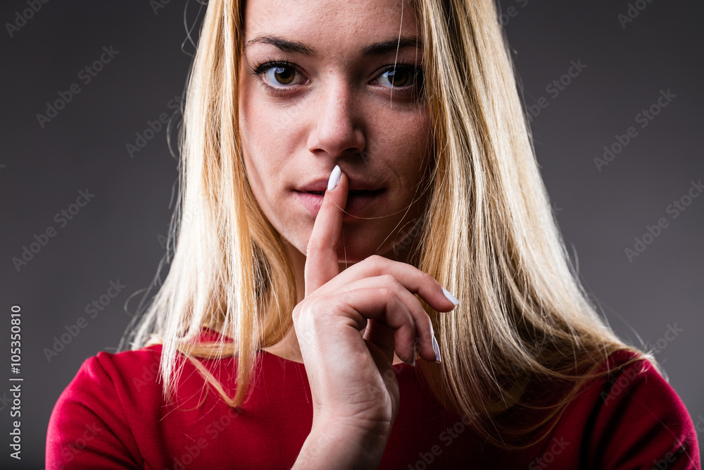 Naklejka premium woman with finger on her lips