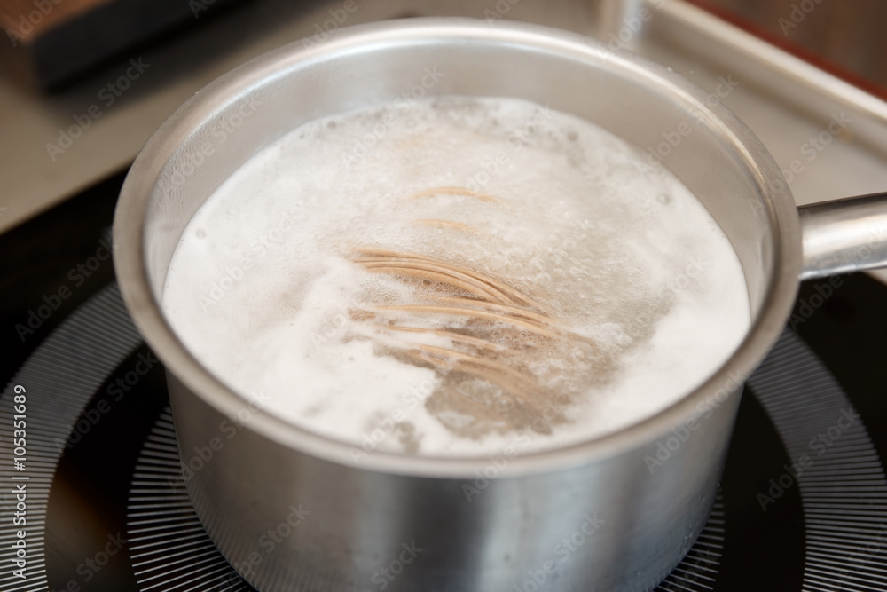 Noodles being cooked in boiling water Noodles being cooked in boiling water