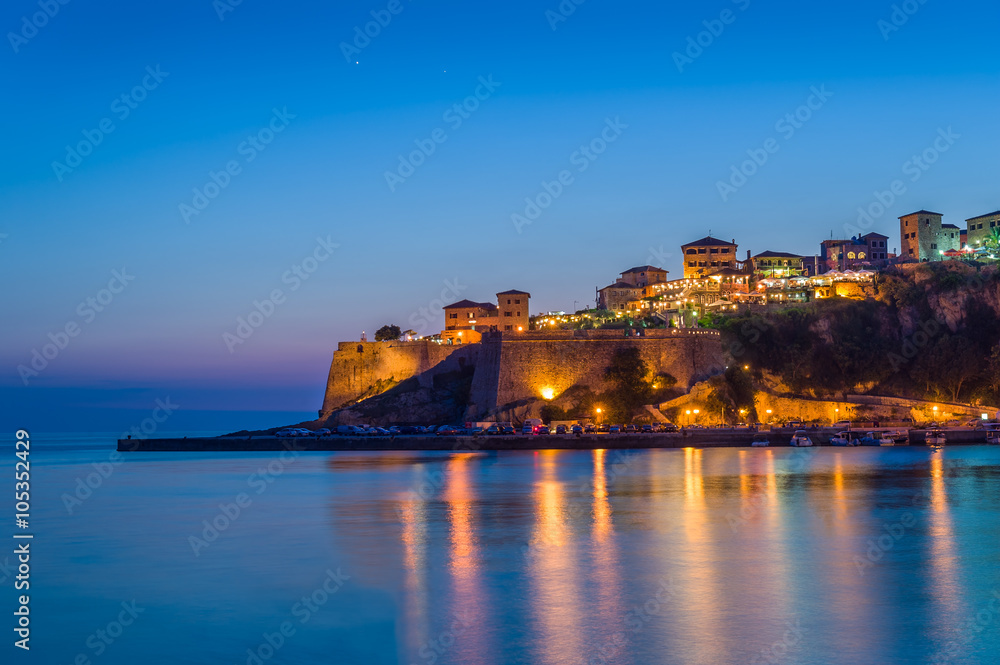 Ulcinj old town fortress at night with silky water and stars on a sky.