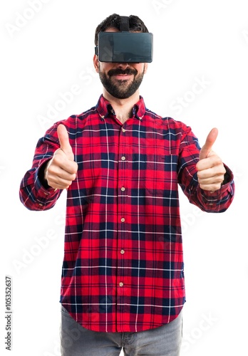 Man using VR glasses with thumb up