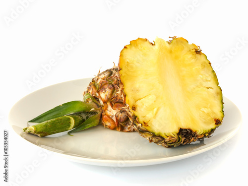 Pineapple cut in half on dish